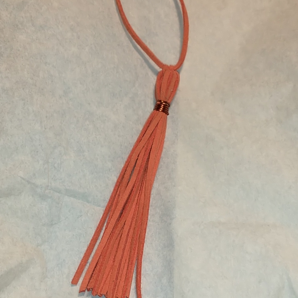 Coral colored faux leather tassel